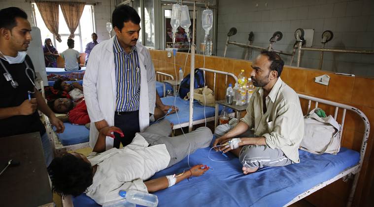 A doctor checks patients suffering from dengue fever at a government hospital in New Delhi, India, Thursday, Sept. 17, 2015. India's capital struggles with its worst outbreak of the dengue fever in five years. Outbreaks of the mosquito-borne disease are reported every year after the monsoon season that runs from June to September. (AP Photo/Manish Swarup)